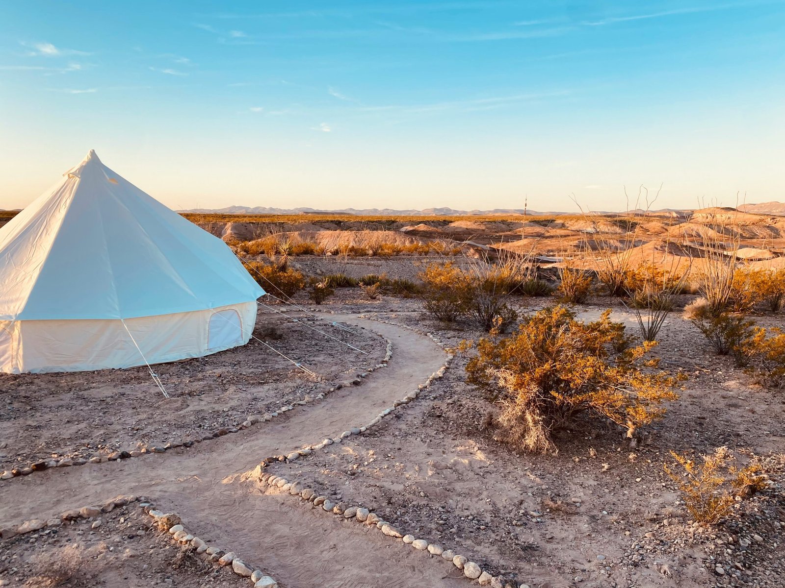 a white tent in the middle of a desert